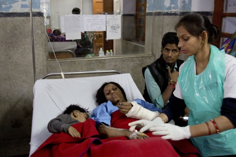 An injured passenger and her son share a bed as they are treated at a hospital in Kanpur, in the northern Indian state of Uttar Pradesh, India, Monday, Nov. 21, 2016. Scores of passengers died and scores more were injured after 14 coaches of an overnight passenger train rolled off the track near Pukhrayan village in Kanpur Dehat district. (AP Photo/Rajesh Kumar Singh)