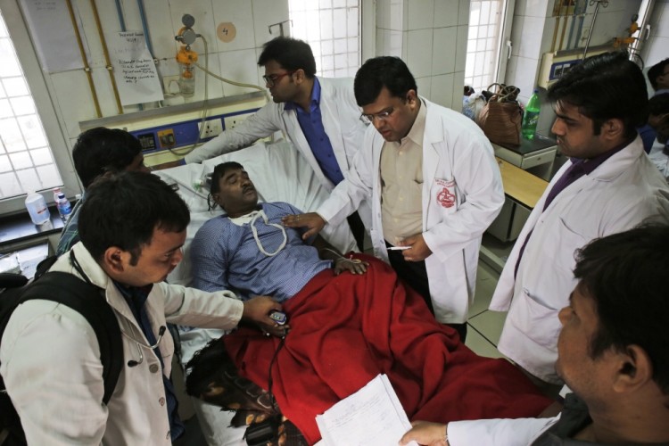 An injured passenger is treated at a hospital in Kanpur, in the northern Indian state of Uttar Pradesh, India, Monday, Nov. 21, 2016. Scores of passengers died and scores more were injured after 14 coaches of an overnight passenger train rolled off the track near Pukhrayan village in Kanpur Dehat district. (AP Photo/Rajesh Kumar Singh)