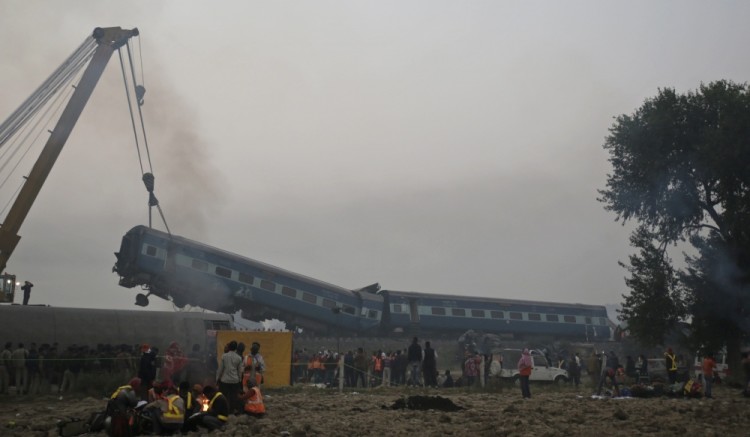 Rescuers work at the site after 14 coaches of an overnight passenger train rolled off the track near Pukhrayan village in Kanpur Dehat district of the northern Indian state of Uttar Pradesh, India, Monday, Nov. 21, 2016. Dozens died and dozens more were injured in the accident. (AP Photo/Rajesh Kumar Singh)