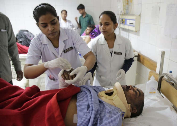 An injured passenger is treated at a hospital in Kanpur, in the northern Indian state of Uttar Pradesh, India, Monday, Nov. 21, 2016. Scores of passengers died and scores more were injured after 14 coaches of an overnight passenger train rolled off the track near Pukhrayan village in Kanpur Dehat district. (AP Photo/Rajesh Kumar Singh)