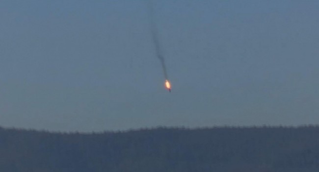This frame grab from video by Haberturk TV, shows a Russian warplane on fire before crashing on a hill as seen from Hatay province, Turkey, Tuesday, Nov. 24, 2015. Turkey shot down the Russian warplane Tuesday, claiming it had violated Turkish airspace and ignored repeated warnings. Russia denied that the plane crossed the Syrian border into Turkish skies. (Haberturk TV via AP)  TURKEY OUT