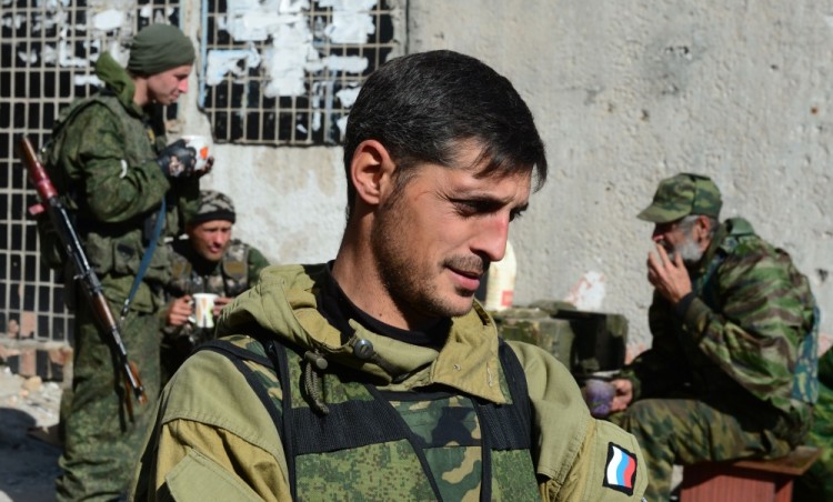 Givi, commander of the pro-Russian separatist Somali battalion, speaks to reporters at a lookout centre of pro-Russian separatist soldiers near Donetsk's Sergey Prokofiev international airport where fighting continues between Ukrainian army forces holed up inside and pro-Russian separatist soldiers, on October 9, 2014. Donetsk's northeastern neighbourhoods close to the airport have seen much of the fighting, as several Ukrainian contingents holed up there since May seek to stave off more than a week of nearly ceaseless rebel attacks. Donetsk city authorities said several residential buildings in the same districts had been destroyed and that two shopping centres had also been hit.  AFP PHOTO / JOHN MACDOUGALL