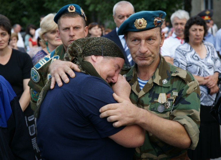 BESLAN, NORTH OSSETIA, RUSSIA. SEPTEMBER 2. 2011. Veteran army serviceman comforts a woman during the unveiling ceremony for the Kind Angel of the World statue to commemorate the victims of the 2004 terror act in a Beslan School. (Photo ITAR-TASS / Vladimir Mukagov)