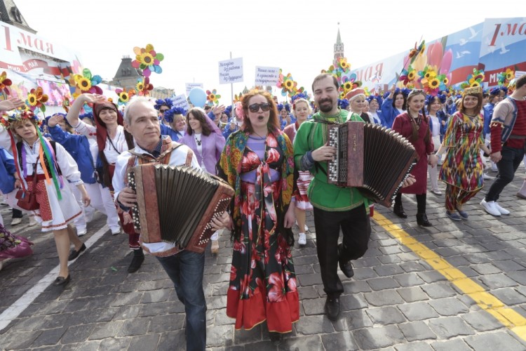 Russians wave flags and sing songs as they walk on Red Square to mark May Day in Moscow, Russia, Monday, May 1, 2017. As in Soviet times, people paraded across Red Square, but instead of red flags with the Communist hammer and sickle, they waved the Russian tricolor. (AP Photo/Ivan Sekretarev)
