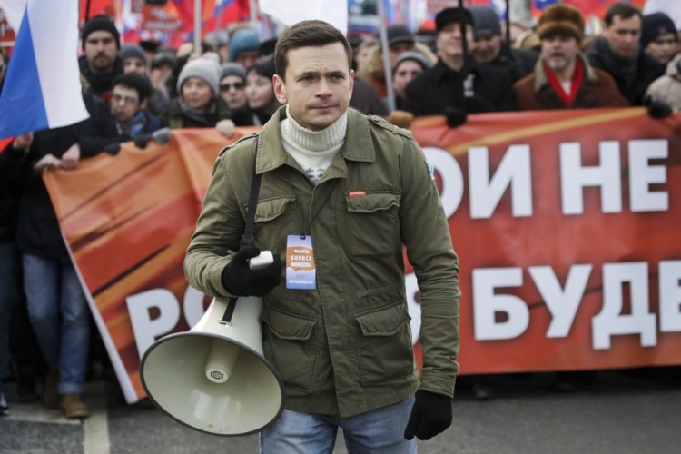 Russian opposition activist Ilya Yashin holds a loudspeaker during a march in memory of opposition leader Boris Nemtsov, in Moscow, Russia, Sunday, Feb. 26, 2017. Thousands of Russians take to the streets of downtown Moscow to mark two years since Nemtsov was gunned down outside the Kremlin. (AP Photo/Pavel Golovkin)