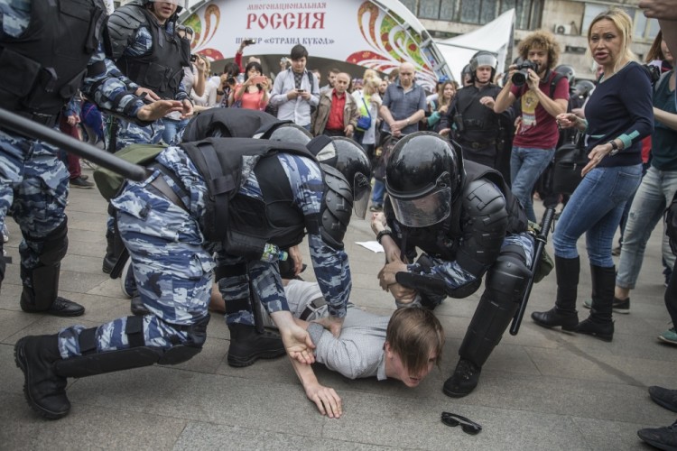 Police detain a protester In Moscow, Russia, Monday, June 12, 2017. Demonstrators in Monday's opposition protests across Russia say they are fed up with endemic corruption among officials. The protest gatherings in cities from Far East Pacific ports to St. Petersburg were spearheaded by Alexei Navalny, the anti-corruption campaigner who has become the Kremlin's most visible opponent. (Evgeny Feldman/Pool Photo via AP)