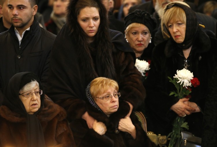 Mother of Andrei Karlov, Maria, left, his widow Marina, second left, attend a religious service for killed Russian ambassador to Turkey, Andrei Karlov inside the Christ the Saviour Cathedral in Moscow, Russia, Thursday, Dec. 22, 2016. Karlov was fatally shot by a Turkish policeman Monday in a gathering in Ankara, Turkey. (AP Photo/Alexander Zemlianichenko)