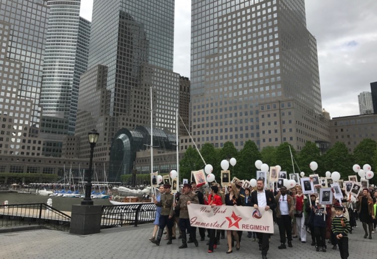 NEW YORK CITY, USA - MAY 7, 2017: People hold portraits of their family members who fought in WWII during an Immortal Regiment memorial event marking the 72nd anniversary of the Victory over Nazi Germany in the Second World War. Natalya Slavina-Shkretova/TASS