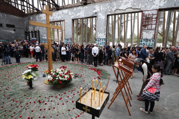 BESLAN, RUSSIA - SEPTEMBER 1, 2017: People mourn during an event in memory of the victims of the 2004 Beslan school siege in the gym of School No 1. On September 1, 2004, a group of Chechen militants took more than 1,200 people hostage; the hostage crisis lasted for 3 days, leaving 334 people dead, including 186 children. Sergei Savostyanov/TASS