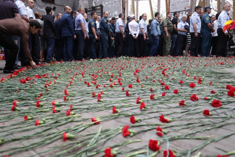 BESLAN, RUSSIA - SEPTEMBER 1, 2017: People lay red carnations on the floor during an event in memory of the victims of the 2004 Beslan school siege in the gym of School No 1. On September 1, 2004, a group of Chechen militants took more than 1,200 people hostage; the hostage crisis lasted for 3 days, leaving 334 people dead, including 186 children. Sergei Savostyanov/TASS