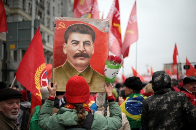 MOSCOW, RUSSIA  NOVEMBER 7, 2017: A girl holds a portrait of Soviet leader Joseph Stalin as the Russian Communist Party rallies to mark the centenary of the 1917 Bolshevik Revolution. Sergei Bobylev/TASS