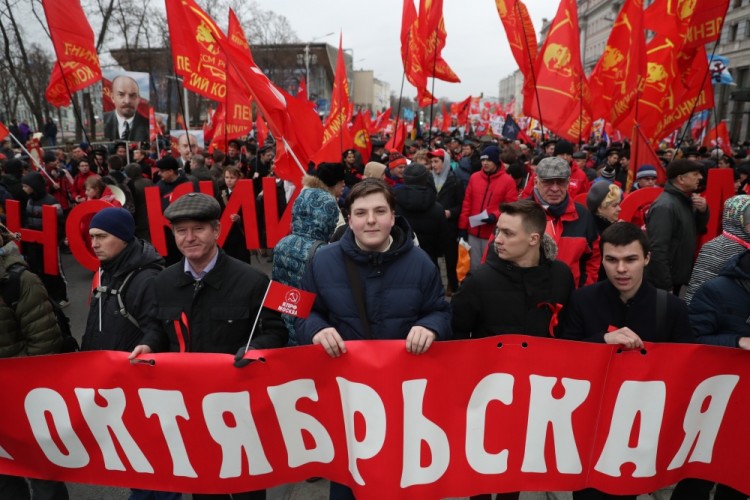 MOSCOW, RUSSIA  NOVEMBER 7, 2017: People carry red flags and a portrait of Russian revolutionary Vladimir Lenin as the Russian Communist Party rallies to mark the centenary of the 1917 Bolshevik Revolution. Valery Sharifulin/TASS