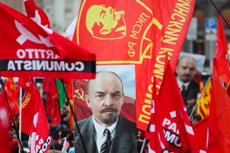 MOSCOW, RUSSIA  NOVEMBER 7, 2017: People carry red flags and a portrait of Russian revolutionary Vladimir Lenin as the Russian Communist Party rallies to mark the centenary of the 1917 Bolshevik Revolution.  Sergei Bobylev/TASS