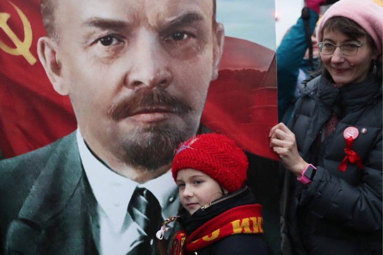 MOSCOW, RUSSIA  NOVEMBER 7, 2017: A girl seen by a portrait of Russian revolutionary Vladimir Lenin as the Russian Communist Party rallies to mark the centenary of the 1917 Bolshevik Revolution.  Valery Sharifulin/TASS