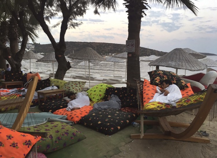A man sleeps on the beachfront after spending the night outdoors following an earthquake in Bitez, a resort town about 6 kilometers (4 miles) west of Bodrum, Turkey, Friday, July 21, 2017. A powerful earthquake struck Turkey's Aegean coast and nearby Greek islands, sending frightened residents running out of buildings they feared would collapse and into the streets. (AP Photo/Ayse Wieting)