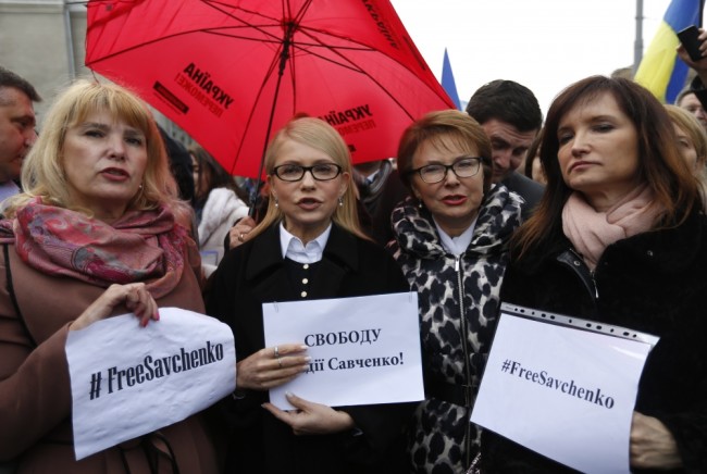 Yulia Tymoshenko, former prime minister and Fatherland party leader, center left, takes part in rally to support of Ukrainian pilot Nadezhda Savchenko outside the Russian Embassy in Kiev, Ukraine, Wednesday, March  9 2016.  A Russian judge set a date of March 21-22 for issuing the verdict in the case against jailed Ukrainian pilot Nadezhda Savchenko, who is accused of involvement in the deaths of two Russian journalists during the conflict in eastern Ukraine. The judge said Wednesday, March 9, 2016, the reading of the verdict would begin March 21 and take two days. (AP Photo/Sergei Chuzavkov)