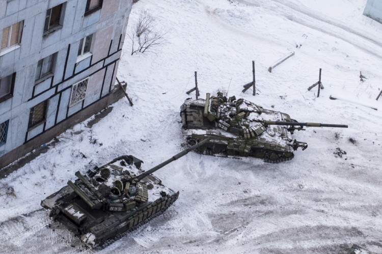 Ukrainian tanks stand in the yard of an apartment block in Avdiivka, eastern Ukraine, Wednesday, Feb. 1, 2017. Heavy fighting around government-held Avdiivka, just north of the rebel-stronghold city of Donetsk, began over the weekend and persisted into early Wednesday. The Contact Group called for the opposing sides to cease fire and urged them to pull back their heavy weapons by the end of the week. (AP Photo/Evgeniy Maloletka)