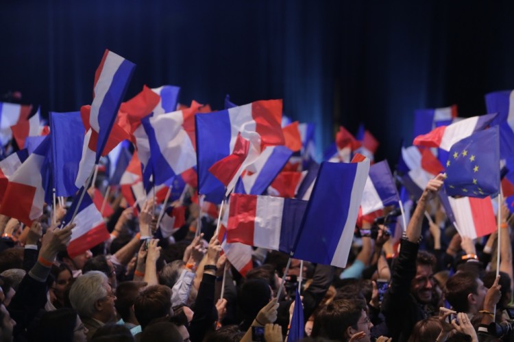Macron supporters wave French and EU flags while waiting for the polling stations to close. Supporters of Emmanuel Macron, the Presidential candidate from the social liberal political party En Marche! celebrate the exit polls, that see him in first place, ahead of Marine Le Pen from the Front National in the first round of the French Presidential election. (Photo by Michael Debets/Pacific Press) *** Please Use Credit from Credit Field ***