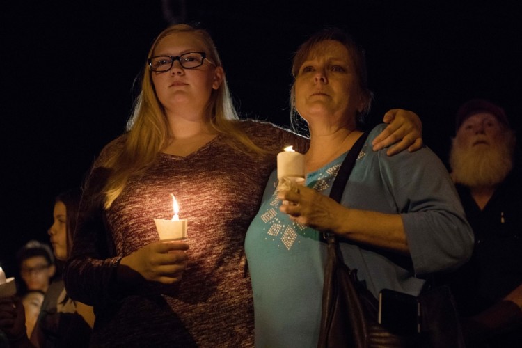 Nov 5, 2017; Sutherland Springs, TX, USA;  Community members gather for a vigil across the street from the First Baptist Church in Sutherland Springs where 26 people where killed in shooting on Sunday. Mandatory Credit: Courtney Sacco/Caller-Times via USA TODAY NETWORK