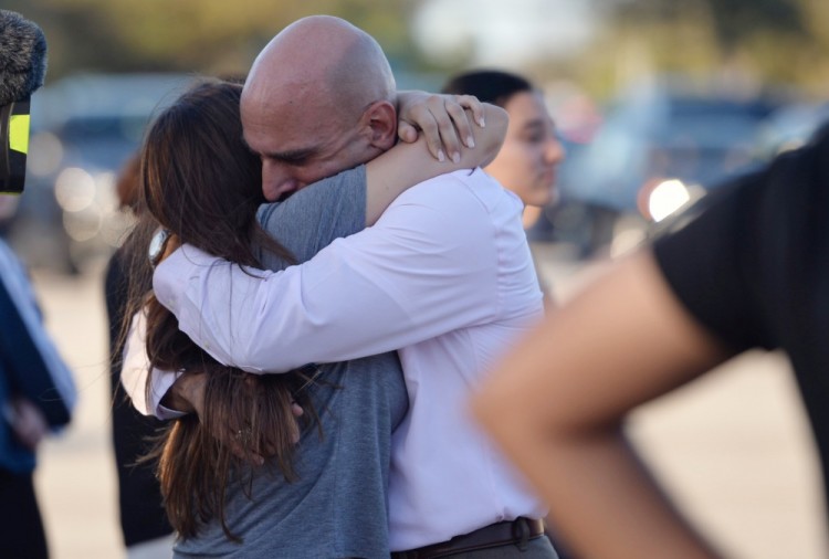 Feb 14, 2018; Parkland, FL, USA; Family members wait for students at University Drive and Holmberg Road after a mass shooting at nearby Marjory Stoneman Douglas High School. Mandatory credit: Xavier Mascarenas/Treasure Coast Newspapers via USA Today Network/Sipa USA